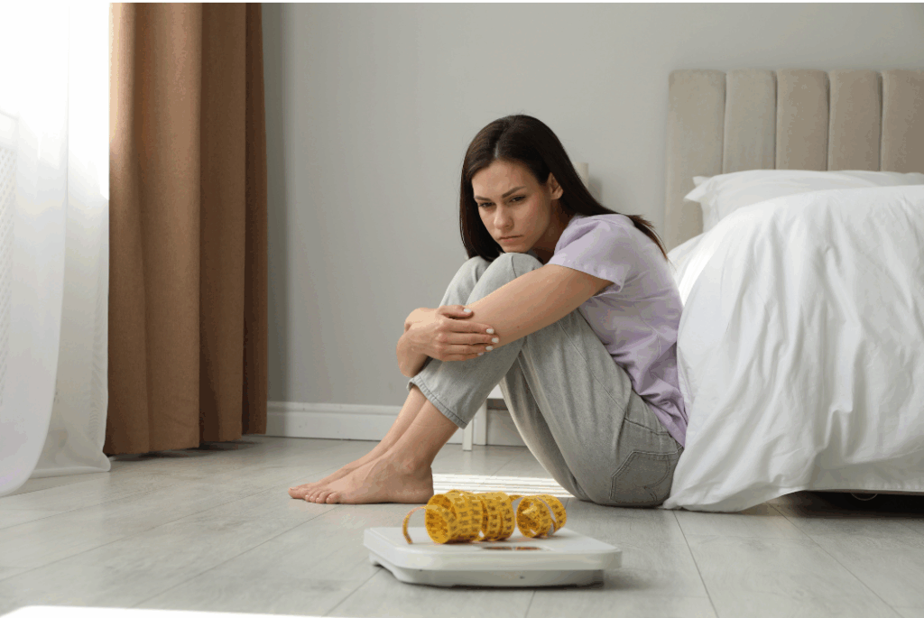 A lady stressed about food because she know she needs counseling for eating disorders.