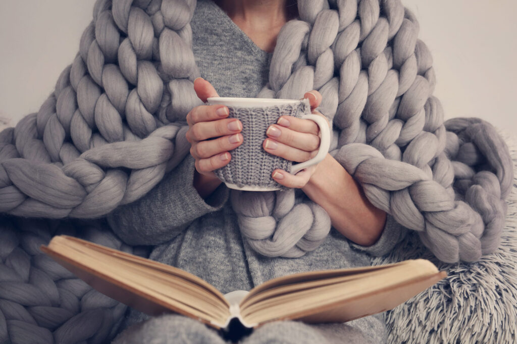 Coping with holiday stress with things that make her feel good such as tea and a good book.