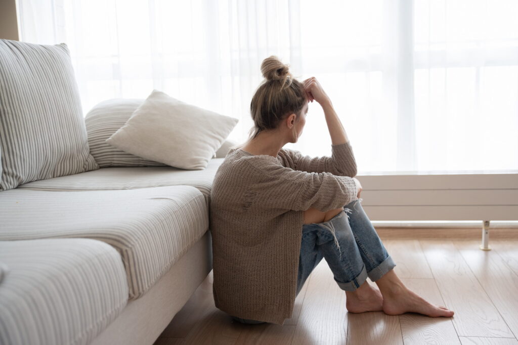 ADHD teen parenting has this woman sitting on the floor exhausted and worried about her teen's future.