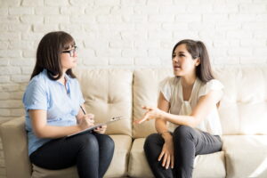 Therapist meeting with a client to discuss out-of-network therapy benefits.